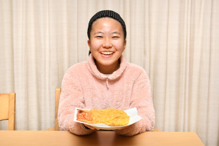 Japanese girl eating Japanese Tempura shrimpの写真素材