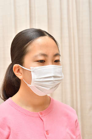 Japanese girl wearing mask not to suffer illnessesの写真素材