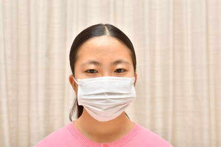 Japanese girl wearing mask not to suffer illnessesの写真素材