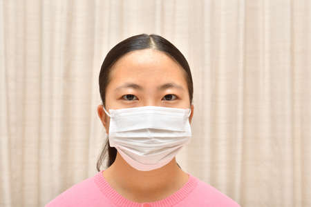 Japanese girl wearing mask not to suffer illnessesの写真素材