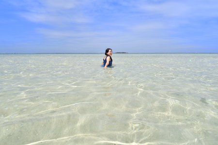 woman swimming in the sea, closeup of photo on mobile phoneの写真素材
