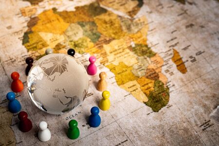 Image of people holding hands around the globeの写真素材