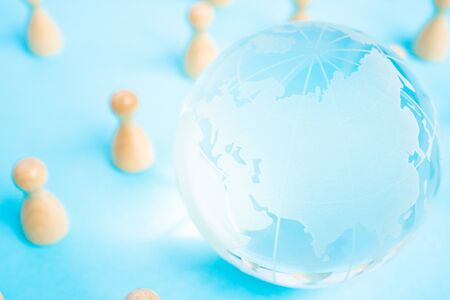 Globe and wooden miniature dollの写真素材