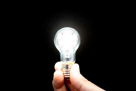 Glowing Light Bulb on Black Background,Inspire Ideas