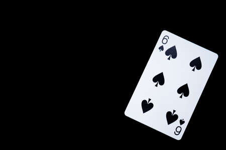 Playing card on a black background, spade 6