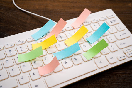 A lot of sticky notes on the keyboard.の写真素材