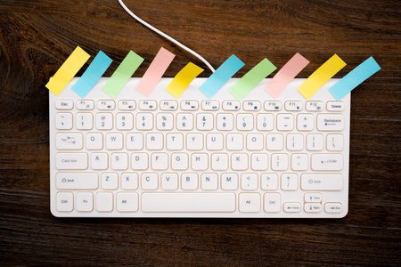 A lot of sticky notes on the keyboard.の写真素材