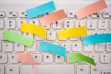 Computer keyboard and lots of notesの写真素材