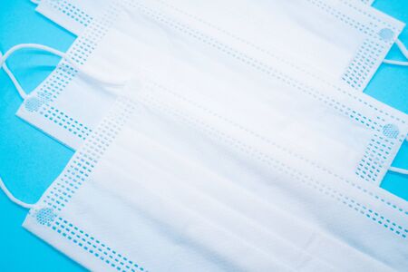 Surgical mask on blue background