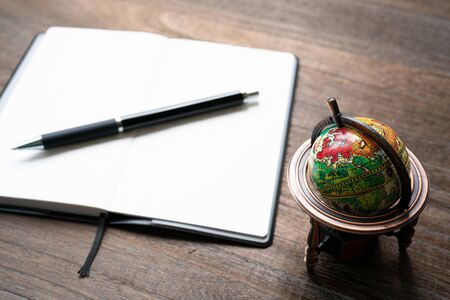 Small globe and business notebookの写真素材