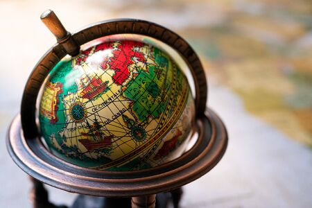 A small globe on a world mapの写真素材