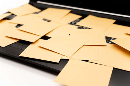 A computer with many sticky notes on itの写真素材