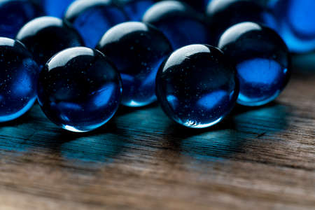 Beautiful blue marbles on a wooden table
