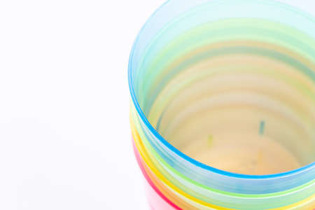 Multi-colored plastic cups on white backgroundの写真素材