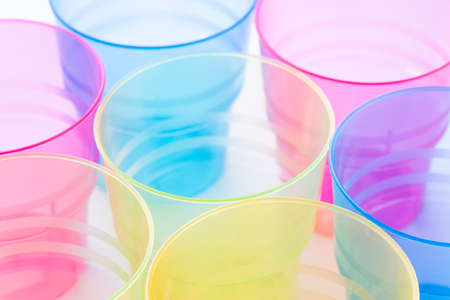 Multi-colored plastic cups on white backgroundの写真素材