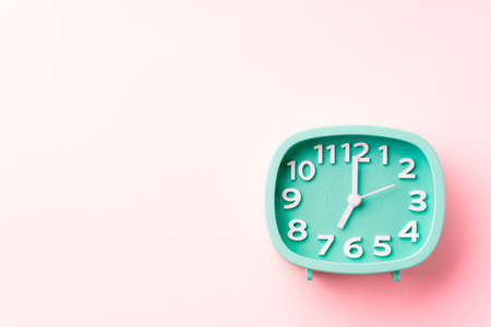 7:00, 19:00, green clock on pink backgroundの写真素材