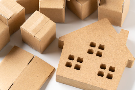 Miniature house and cardboard boxの写真素材