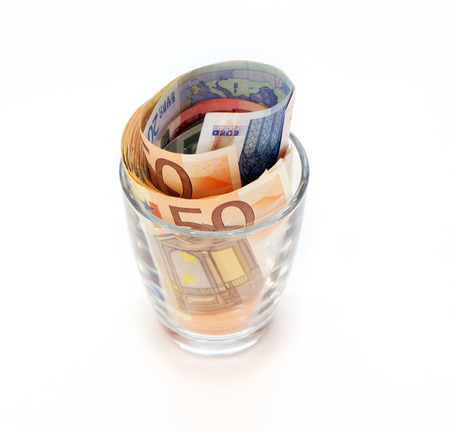 Euro banknotes in a glassの写真素材