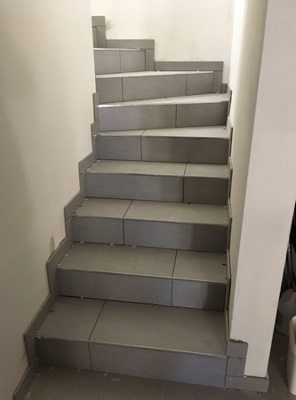 Construction of a new stairs, laying tilesの写真素材