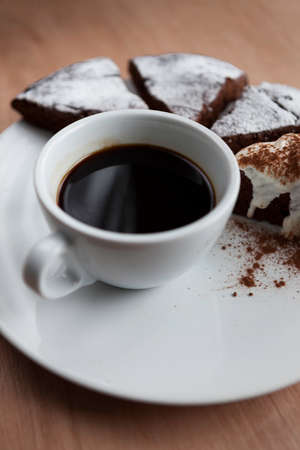Cup of black coffee with chocolate cakeの写真素材