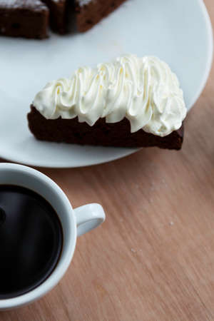 Slice of chocolate cake with black coffeeの写真素材