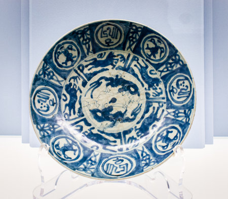 Ceramic plate with a pattern on a blue background. Close-up.の写真素材