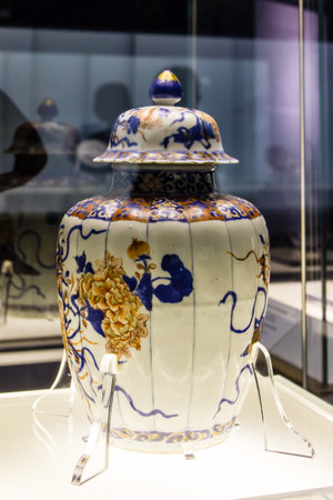 Traditional chinese porcelain plate on a white table with blue background blue and white porcelainの写真素材
