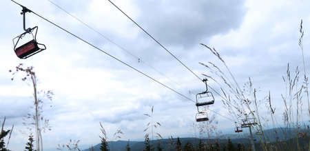 Cableway captured from the ground as a dark silhouette against the blue sky. Giant Mountains (Krkonose), Czech Republic, Bohemian Region.の写真素材