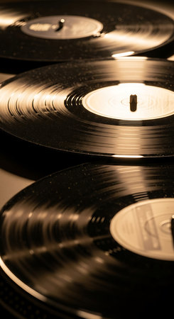 Vinyl records on a black background. Selective focus. Toned.の素材
