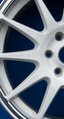 Close-up of a car wheel on a dark blue background.の素材