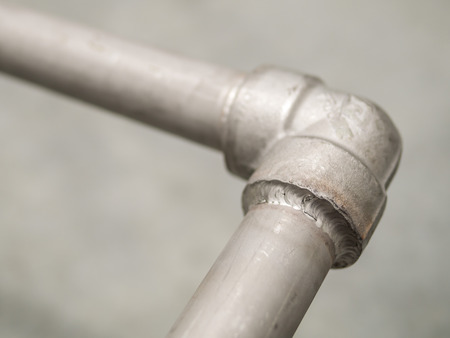 Closeup details seal welded joint in stainless pipeline for outdoor gas supply system