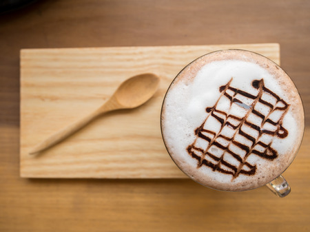 Hot chocolate with milk foam and wooden saucerの写真素材