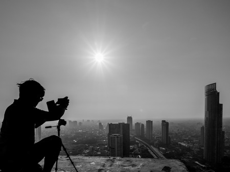 Photographer preparing shooting on rooftopの写真素材
