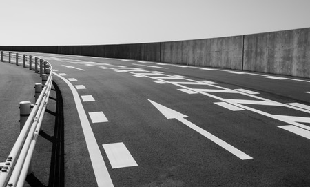 Concrete road with arrow symbol on mountain Cin monochrome style