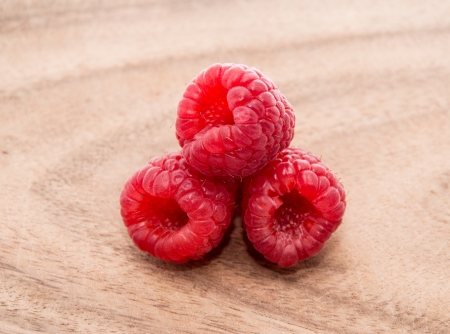 Fresh Raspberries on wooden background
