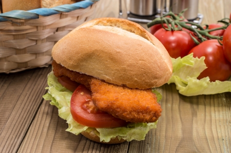 Roll with fried meat on a wooden tableの写真素材