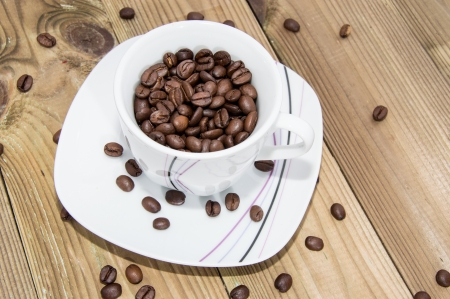 Coffee Beans in a Cup on wooden backgroundの写真素材