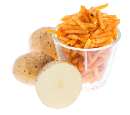 Potato Sticks in a glass with fresh Potatoes isolated on whiteの写真素材