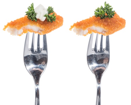 Pieces of fried Fish on a fork isolated on white