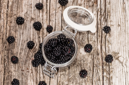 Blackberries in a glass on wooden backgroundの写真素材