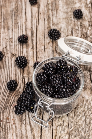 Blackberries in a glass on wooden backgroundの写真素材