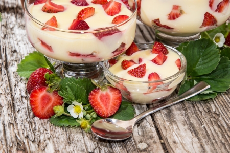 Bowls with Vanilla Pudding and fresh Fruits on wooden backgroundの写真素材