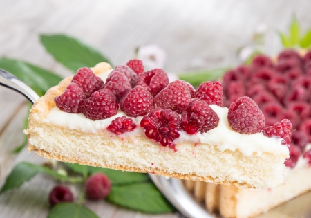 Cake lifter with Raspberry Tart on wooden backgroundの写真素材