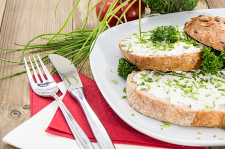 Plate with bread and Cream Cheese on wooden backgroundの写真素材