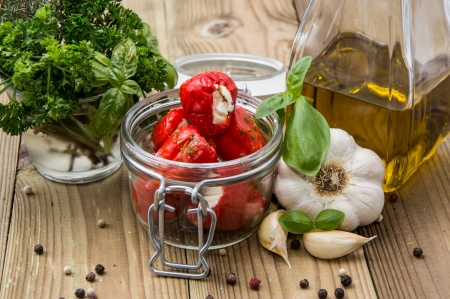 Glass filled with Paprikas against wooden backgroundの写真素材