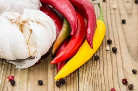 Heap of Chilis with Garlic on wooden backgroundの写真素材