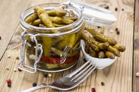 Small Chilis in a glass on wooden backgroundの写真素材