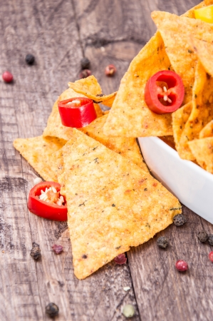 Portion of Nachos with Pepperonis on woodの写真素材