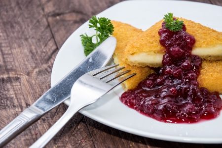 Fried Cheese on a plate against wooden backgroundの写真素材