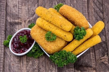 Mozzarella Sticks in a bowl on wooden backgroundの写真素材